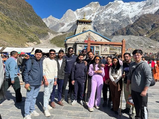 Family group holding Perfect Planners banner at Kedarnath