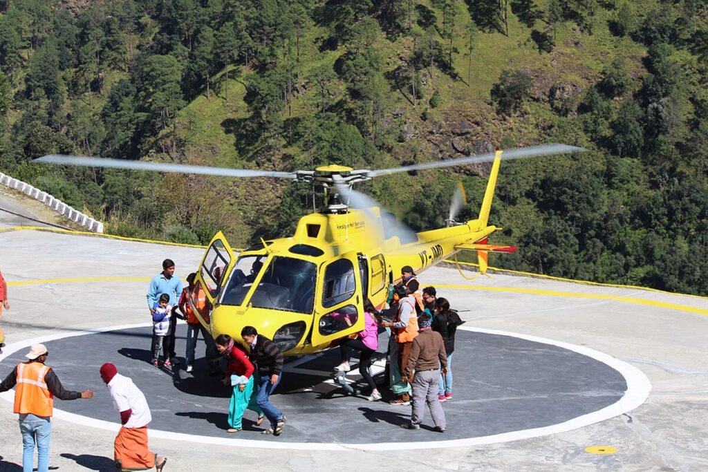 Pilgrims at Kedarnath Temple with snow-covered Himalayan peaks