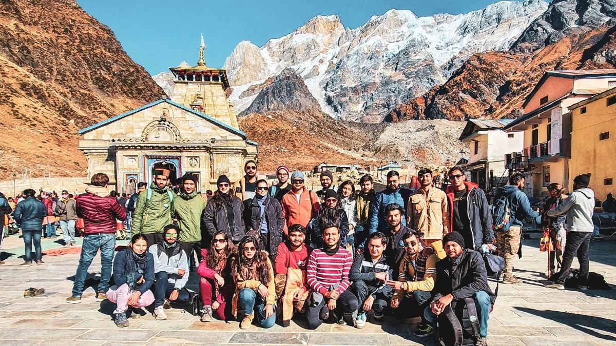 Pilgrims at Kedarnath Temple with snow-covered Himalayan peaks